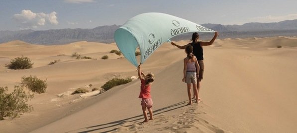  Light like a feather, original and practical. Our idea of the perfect beach towel is that it must be attractive, pleasant and comfortable, but also light as a feather. Nobody likes to go to the beach with a heavy beach bag. But then by doing a very light beach blanket we had an issue with the wind... Very often is windy on the seaside and we all hate when the beach towel moves with the wind, So that's when we created our exclisive fixing system with our reinforced corners and the pins. Working on solving the wind problems, we soon envisioned the opportunity to go much further and create a completely new accessory for the beach. Our fabric is unique, our design is unique and our rolling system for transportation is unique. ÔBABA fully invented something completely different from the conventional beach towel model. Discover all our beach sheets for children or adults, and take advantage of the network of shops which offers our collections of beach towels and beach accessories made in France. Our beach throw is available in many colours, responding to everyone's preferences and tastes. With the range of beach towels we offer (for 1, for 2, for 3 or for a family) you will spend pleasant moments facing the sea... ÔBABA beach blanket will be your practical accessory for this summer. 